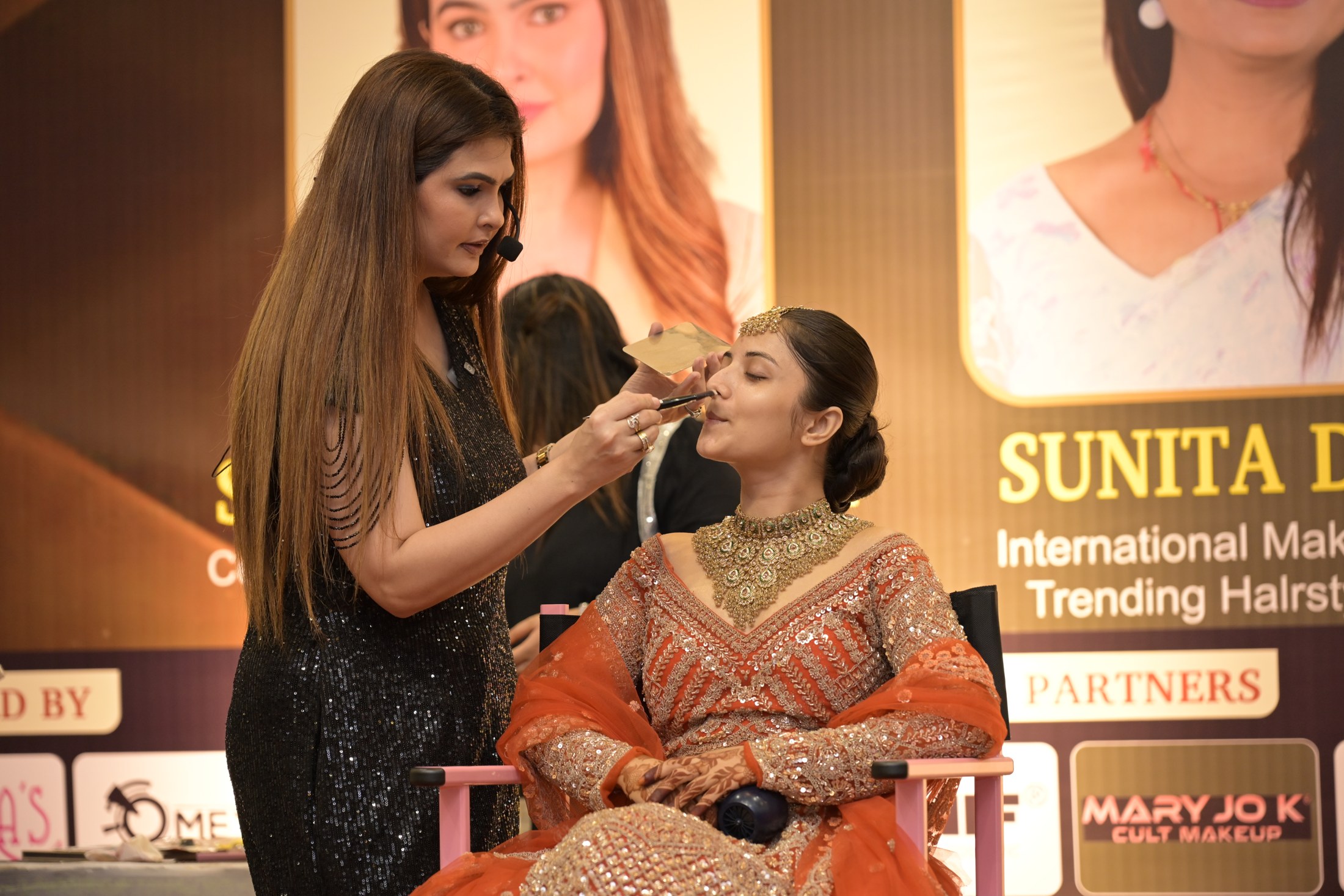 Shabnam Zaveri demonstrating makeup on a model during a live session